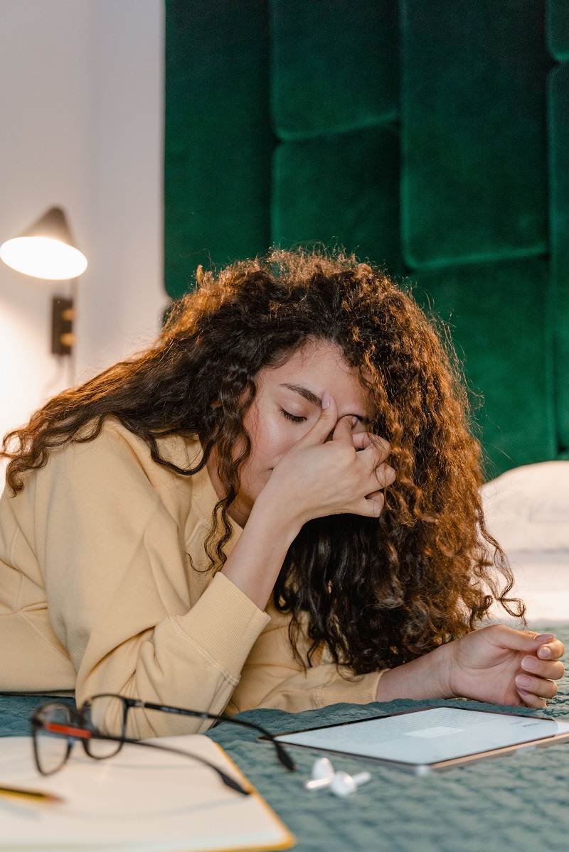 Patient covering their face while sitting in a chair, representing major depressive disorder.