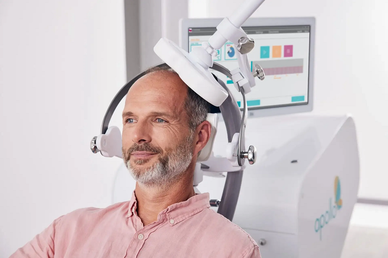 A patient receiving a TMS session while remaining awake and comfortable.